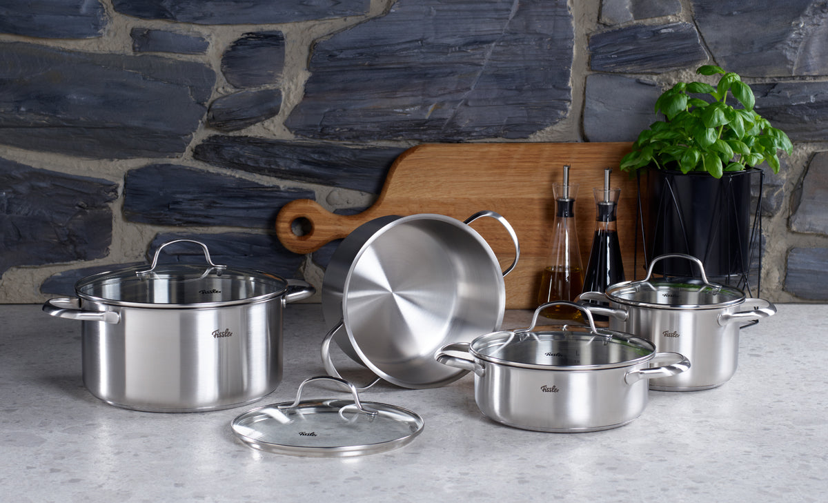 Fissler San Francisco Cookware Set: 3 high-quality pots with glass lids and a super-thermic base, on a stylish kitchen counter. Made in Germany.