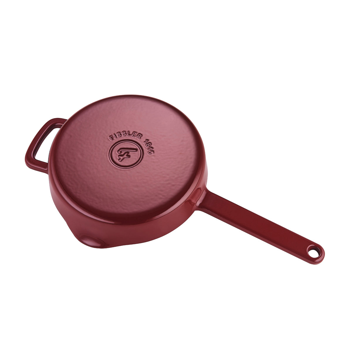 The inverted red Fissler Moments cast iron Frying Pan with textured base, handles and embossed logo stands for durable, efficient German quality.