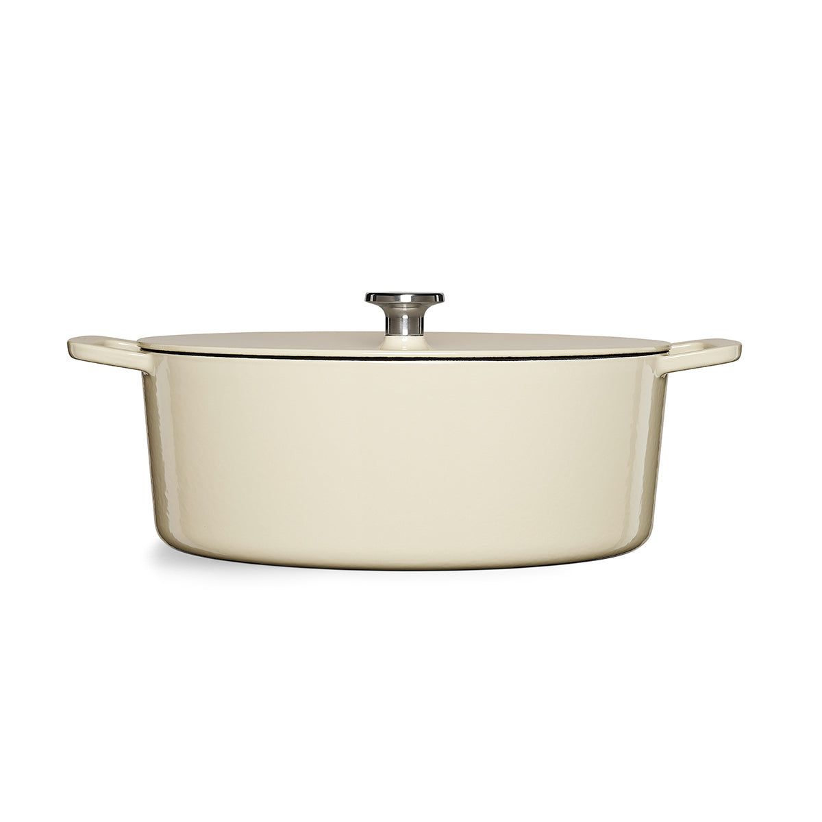 Fissler Moments Cast Iron Casserole Dish: Cream-colored, oval Dutch oven with lid, ergonomic handles, and metal knob - made in Germany.