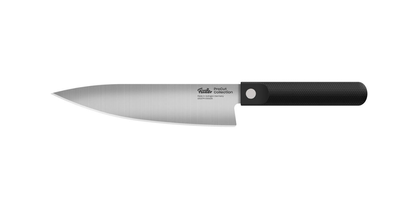 A Fissler stainless steel chef's knife with precision mechanics, a sharp blade, and an ergonomic, black-textured handle in white.
