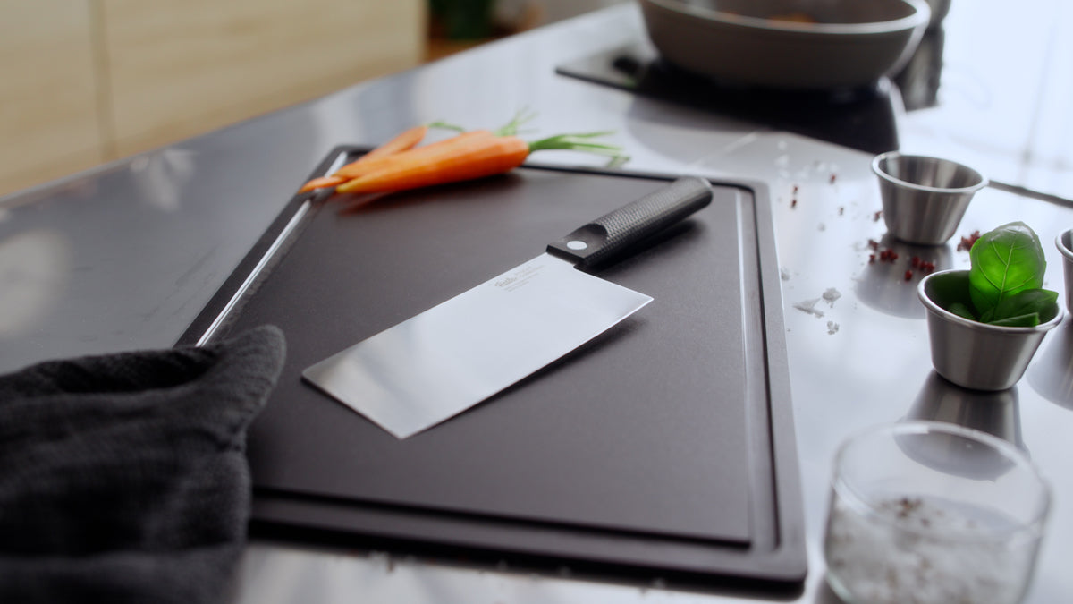 Modern kitchen scene with Fissler ProCut Chinese chef’s knife and Frying Pan, showcasing precision and timeless German design.